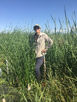 Rae Robinson stands in the wetlands at Farmington Bay Waterfowl Management Area, Courtesy & © Rae Robinson